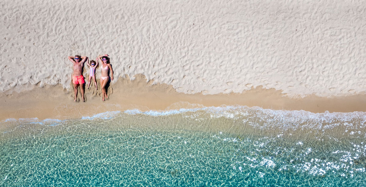 Family laying in the sand