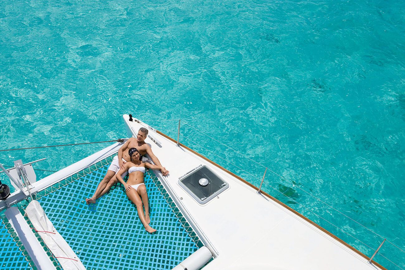 Couple lounging on sailboat beach