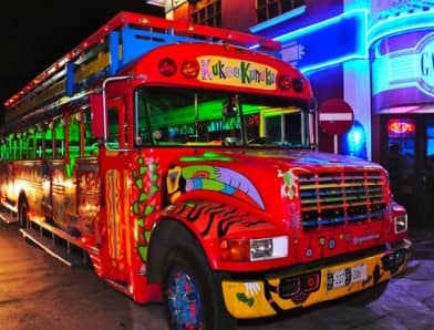 School bus painted red called Kukoo Kunuku