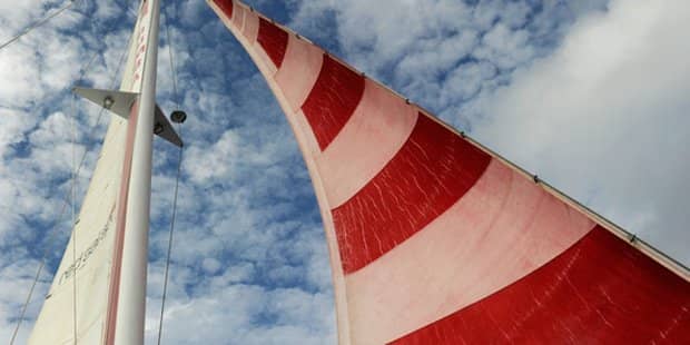 zoomed in photo of red stripe sailboat sail