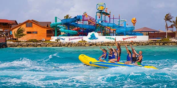 People on banana boat ride in front of water park