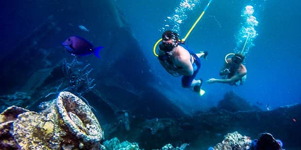 Two tourists snuba diving 