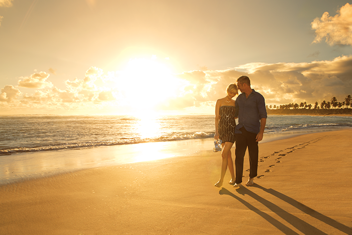 Couple on romantic sunset beach walk 