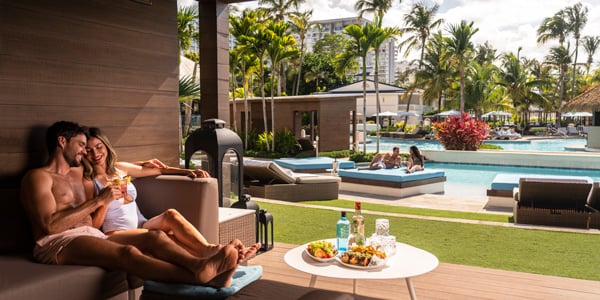 Couple sitting balcony by pool Fairmont El San Juan