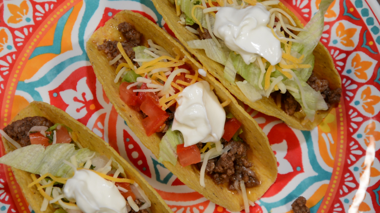 Taco shells, meat, tomatoes, lettuce, cheese and sour cream