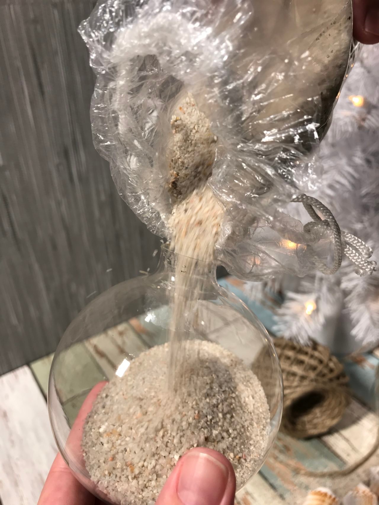 Pouring sand into glass ornament