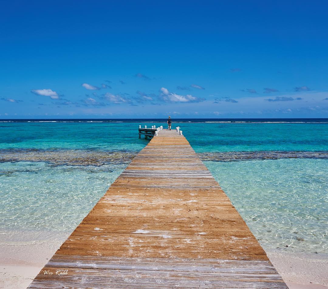 A dock extending out over the ocean. 