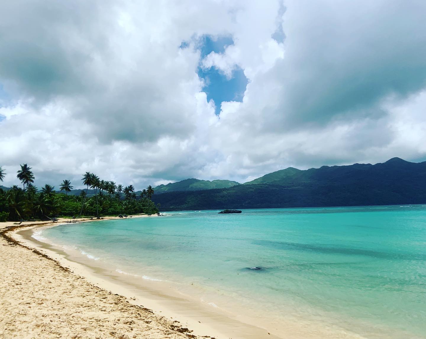 Beach view with mountains in the background. 