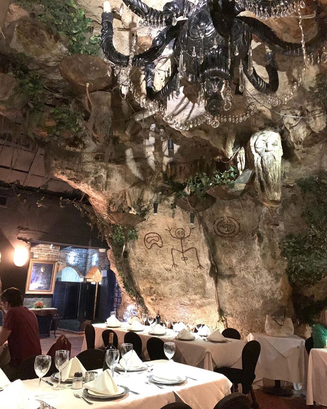 Pictures drawn on walls of cave in restaurant. 