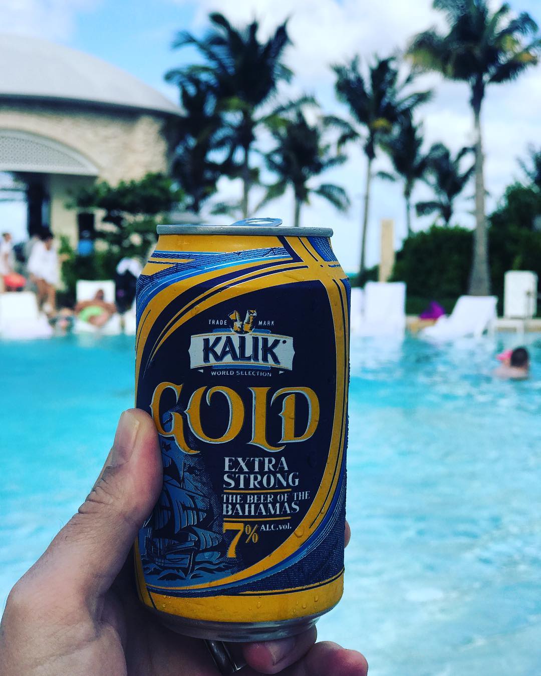 Kalik Gold Beer with pool in the background. 