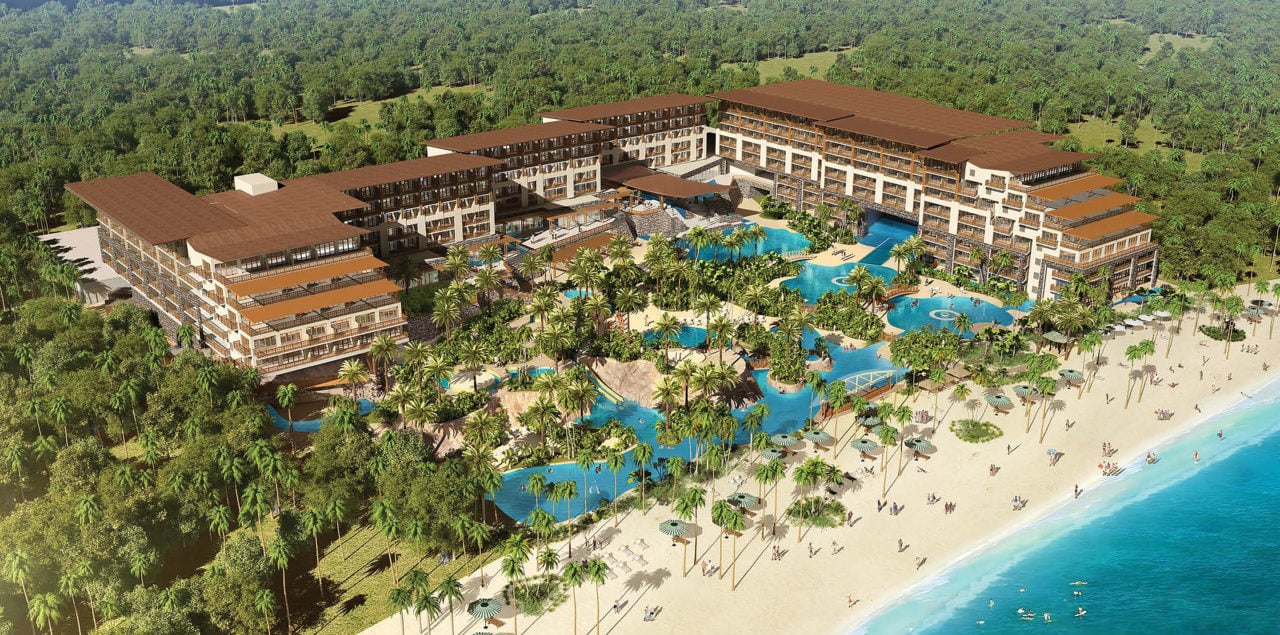 Aerial view of resort with pool and beach. 