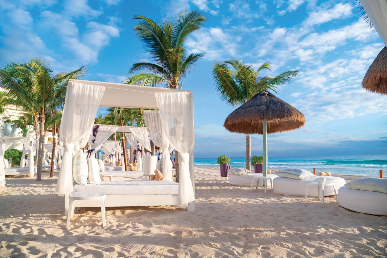 Bali beds and palapas on the beach. 