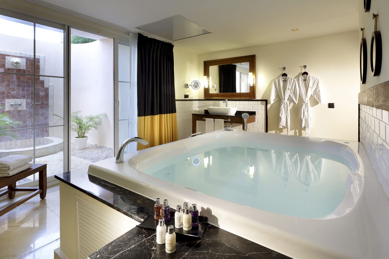 Bathroom with large jacuzzi tub and outdoor shower.