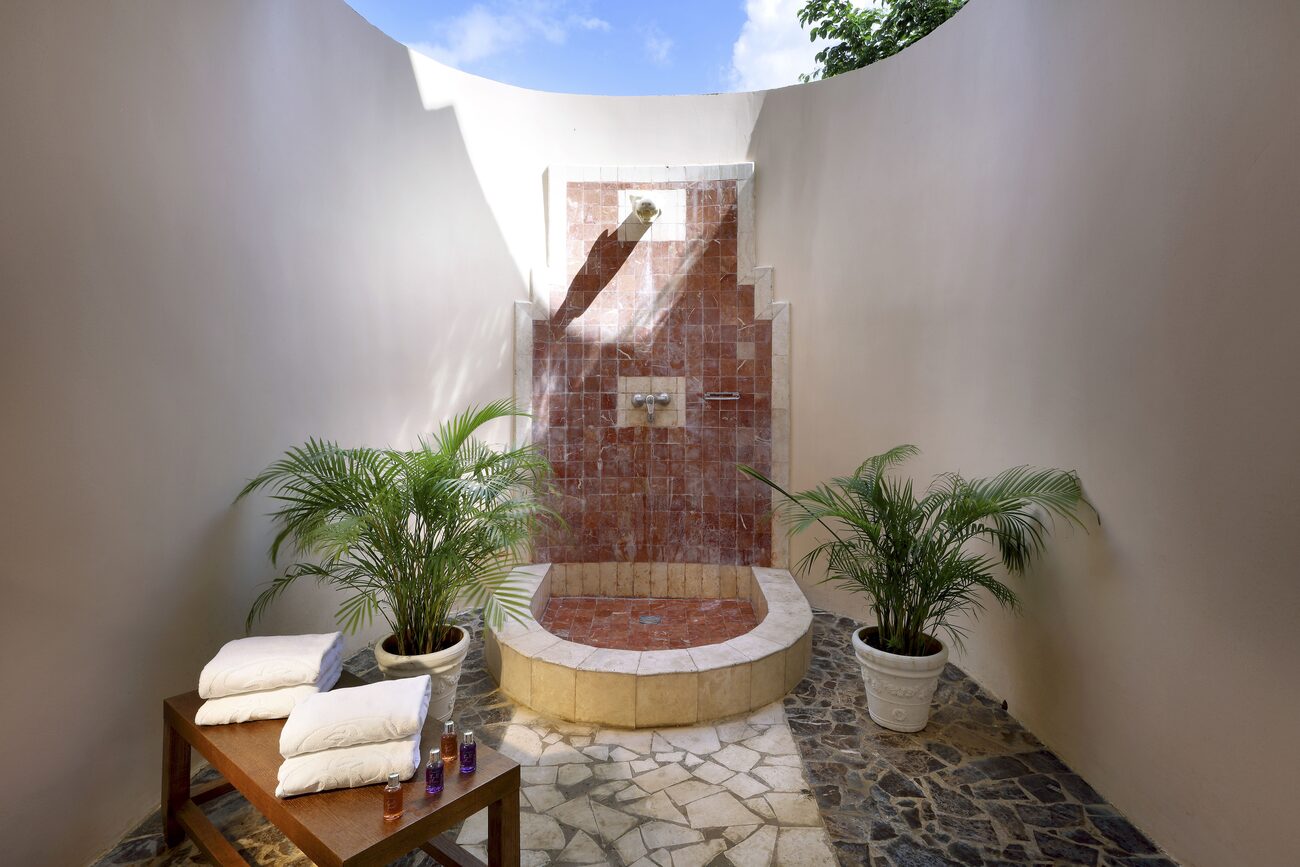 Outdoor shower with bath amenities.