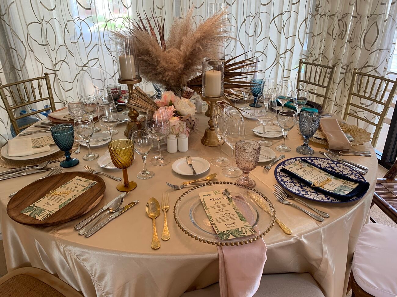 Reception table with place settings and flowers.